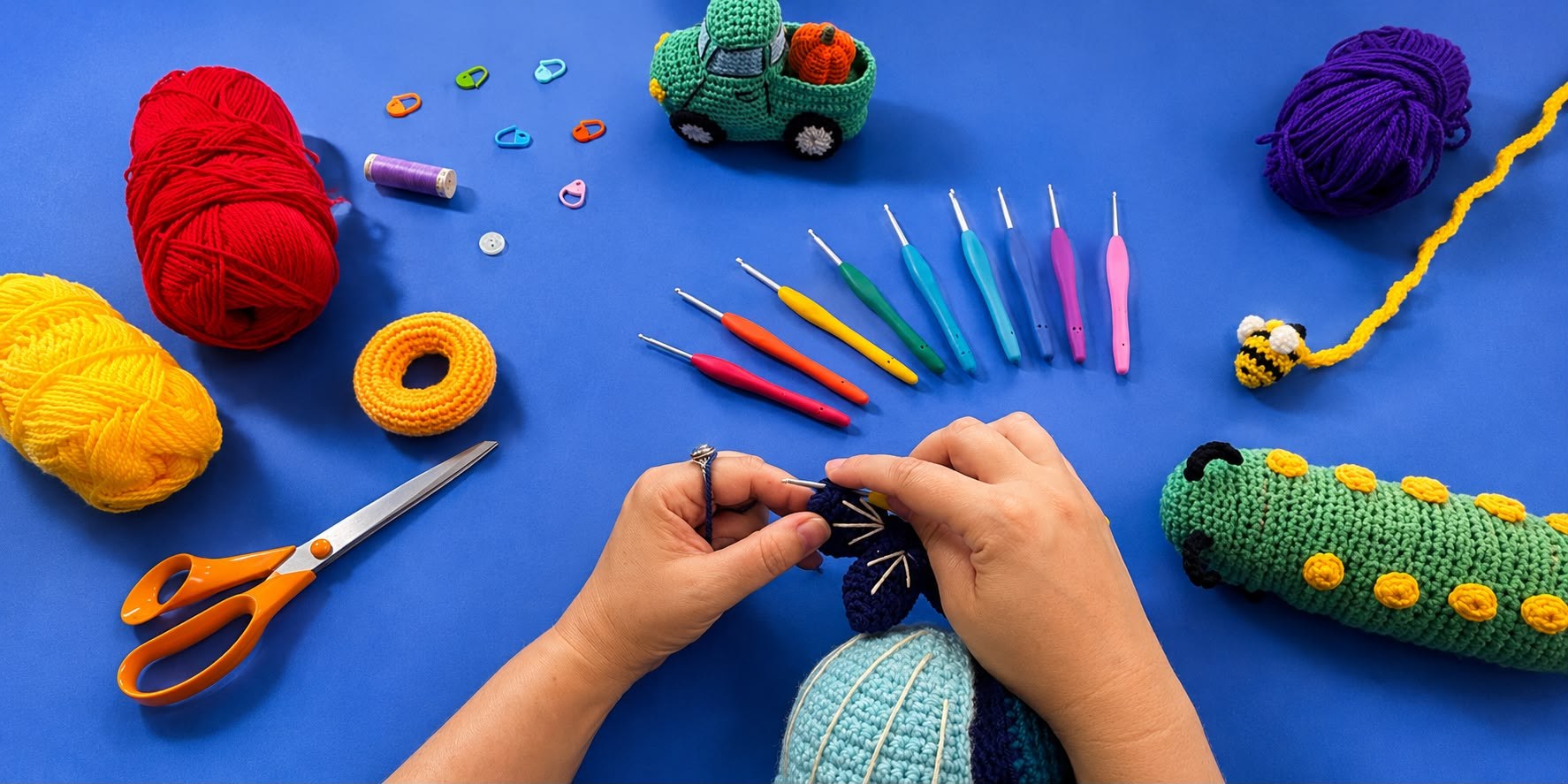 Crocheting a quiet book page by hand, surrounded by yarn, hooks, and finished amigurumi toys